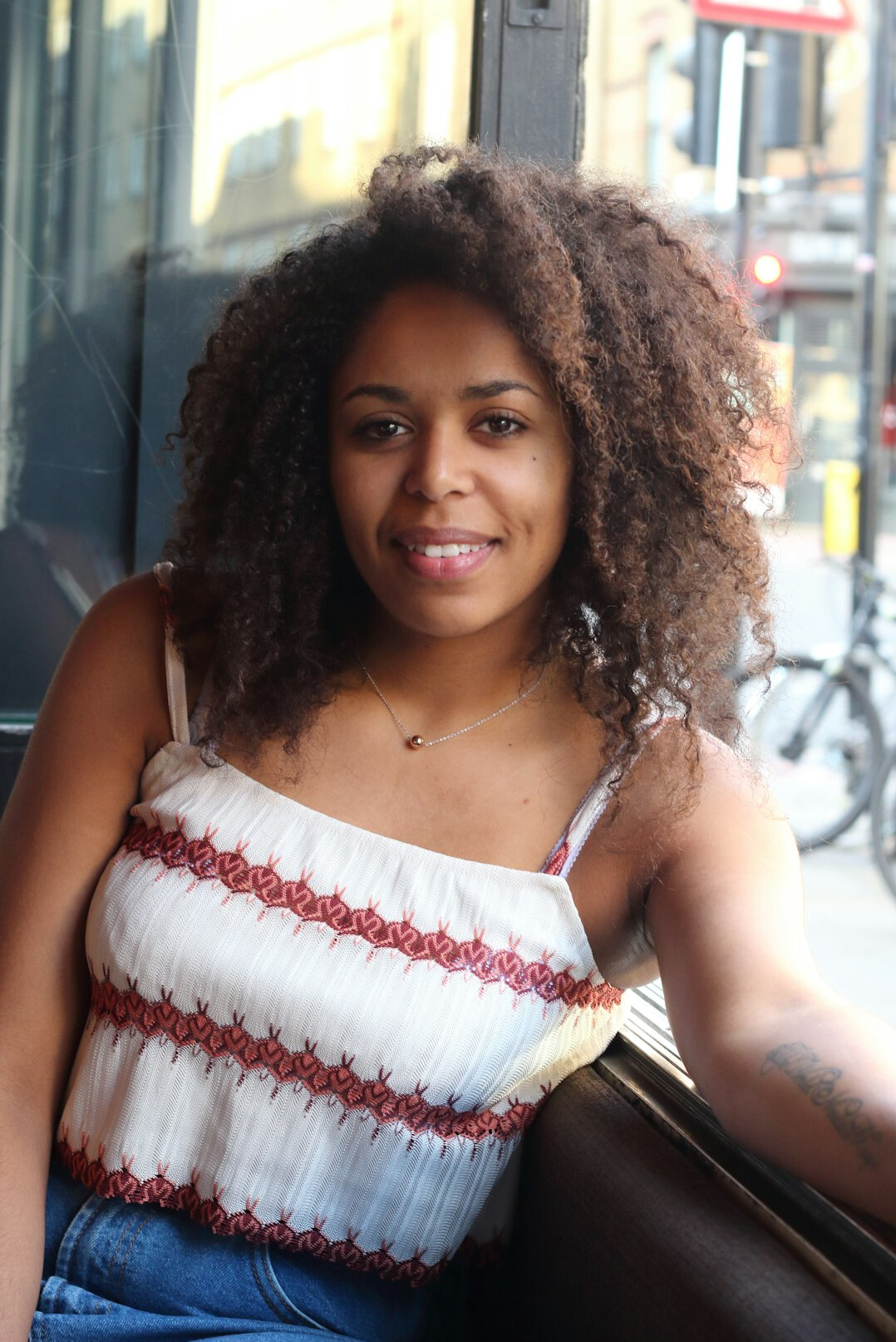 Portrait of a woman with curly hair smiling