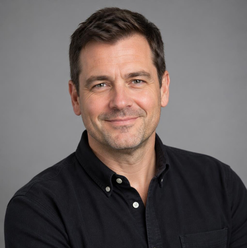 Portrait of a smiling British man in his forties in a dark shirt
